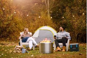 Napoleon Timberwolf Wood Fire Pit outside a tent with people