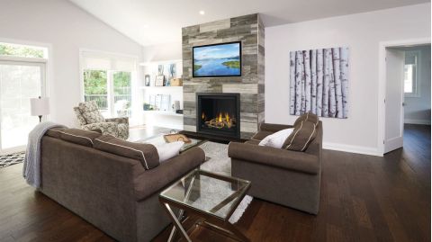 Den with fireplace below tv