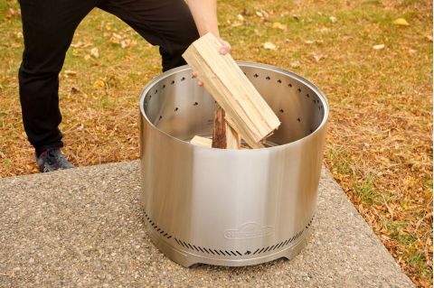 Napoleon Timberwolf Wood Fire Pit adding wood
